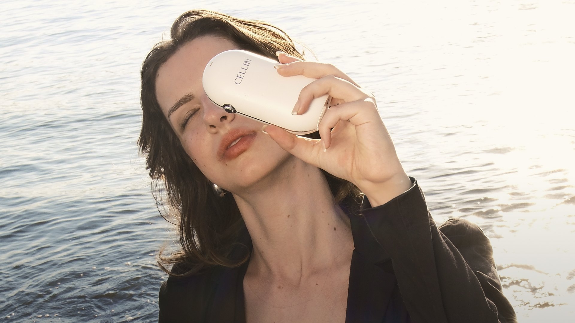 Person enjoying a sunset by the water